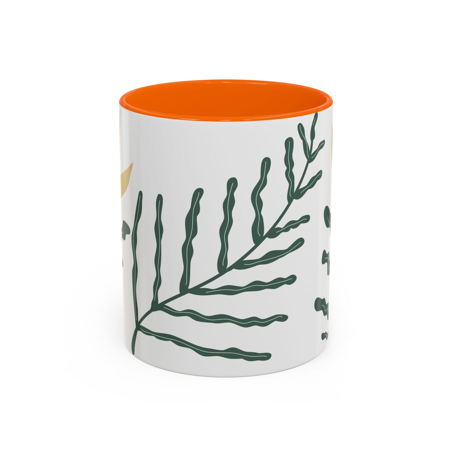 Mug with green leaf pattern and orange interior on a white background