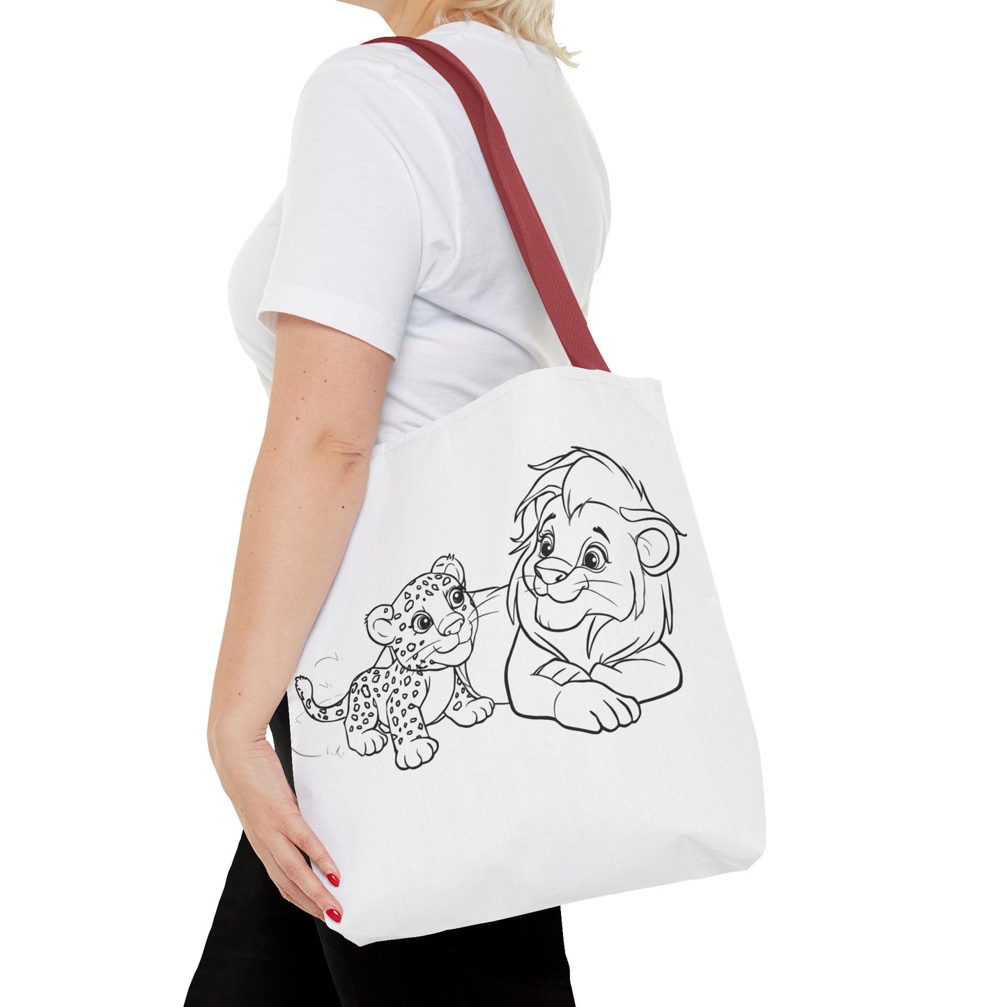 Person holding a tote bag with cartoon lion and cub design on a white background
