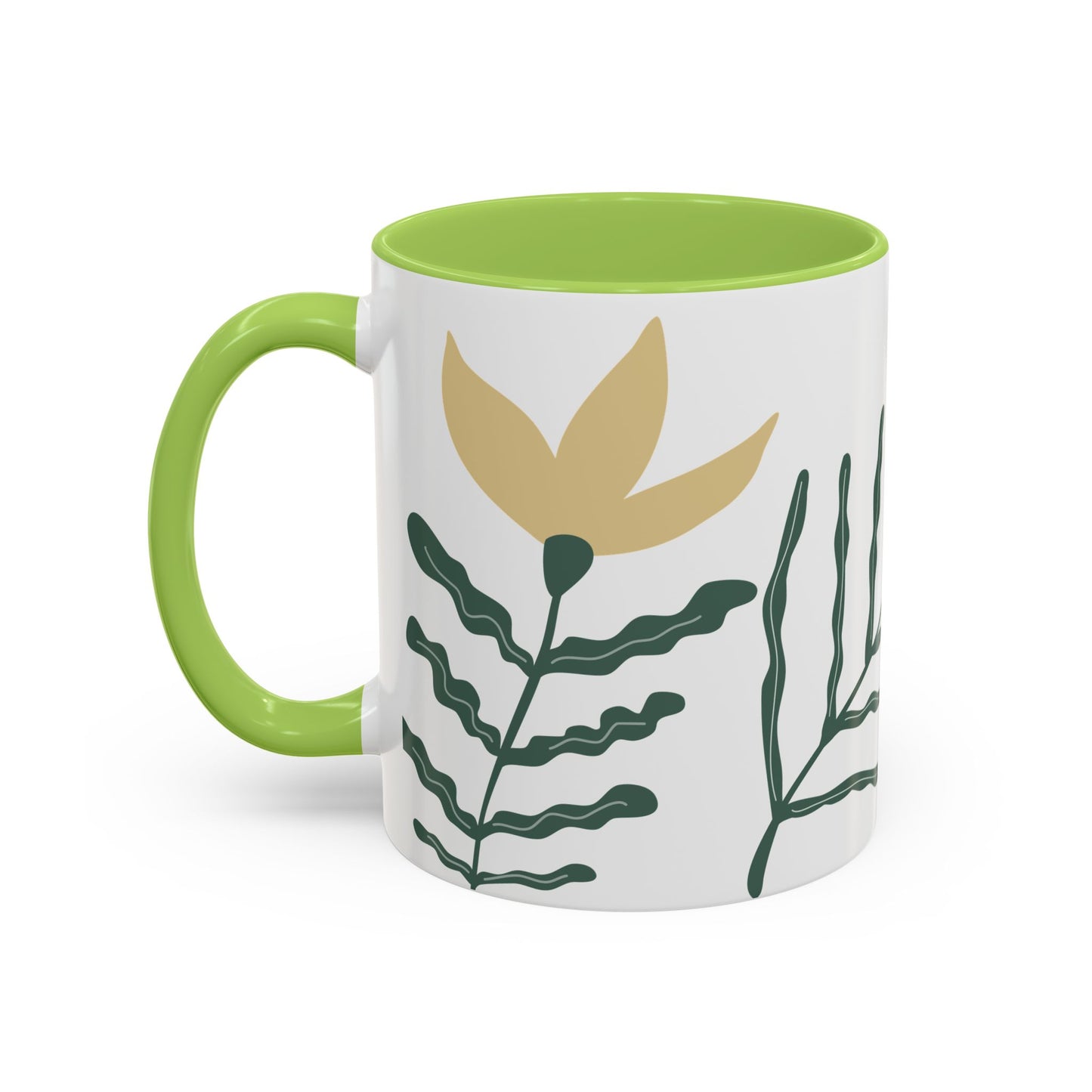 Mug with green handle and leaf design on a white background