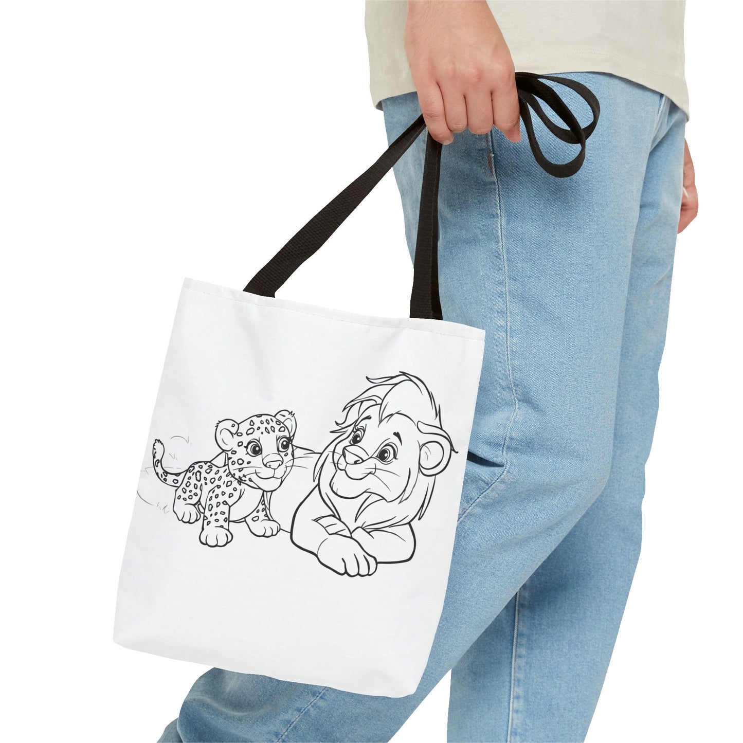 Person holding a tote bag with black line art of a leopard and a character on a white background
