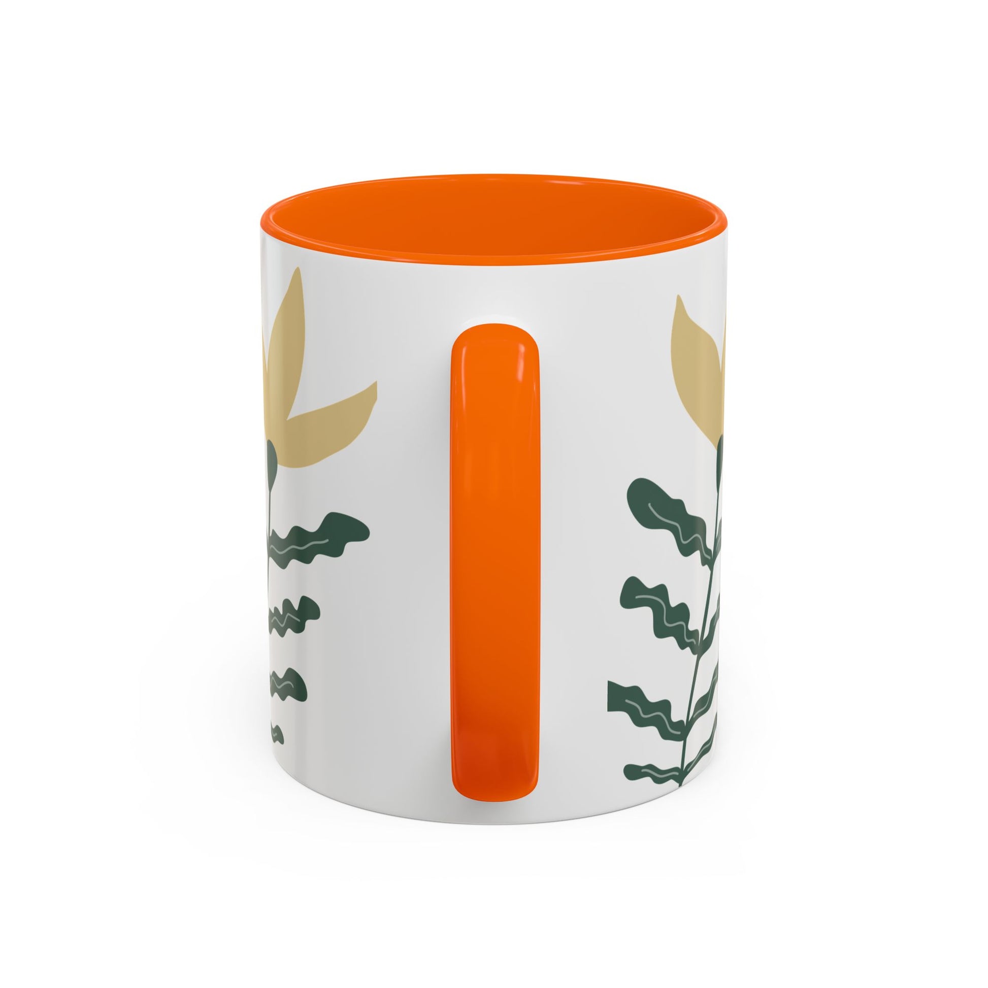 White mug with orange interior and handle, featuring leaf patterns on a white background