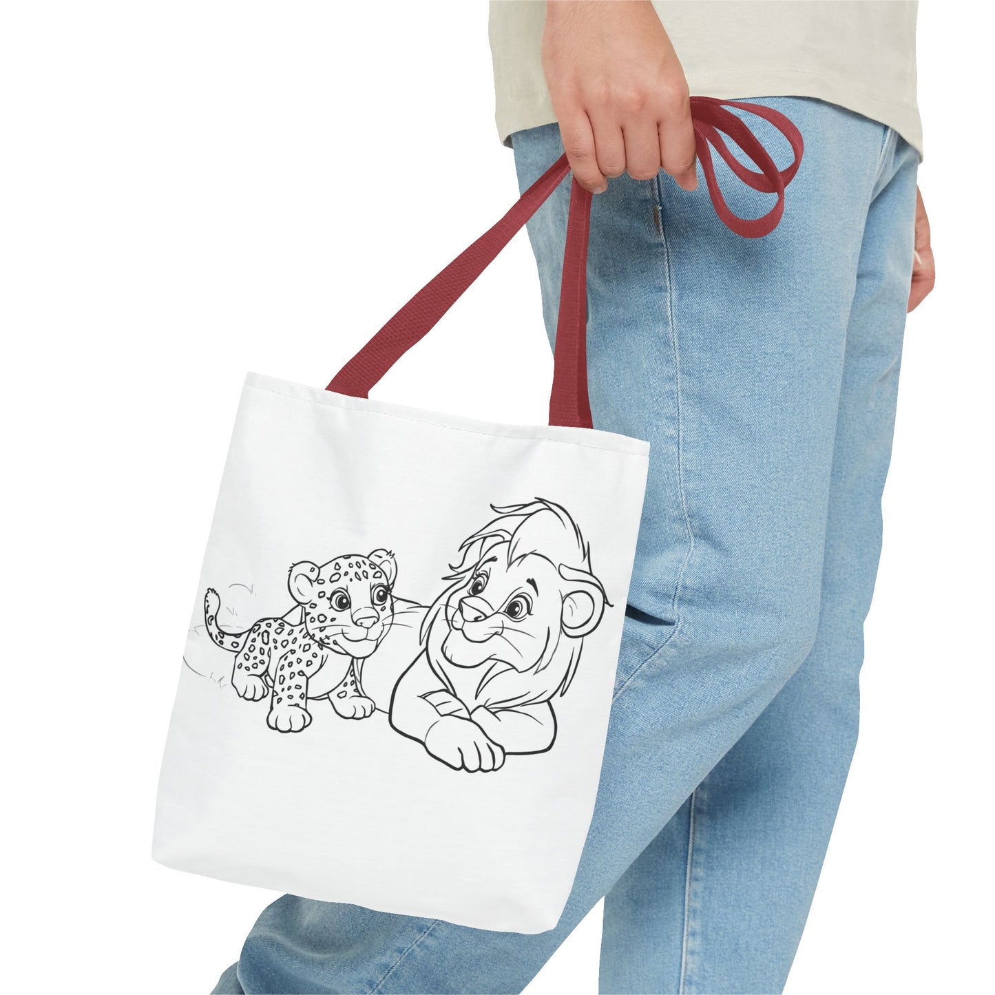 Person holding a tote bag with cartoon characters on a white background