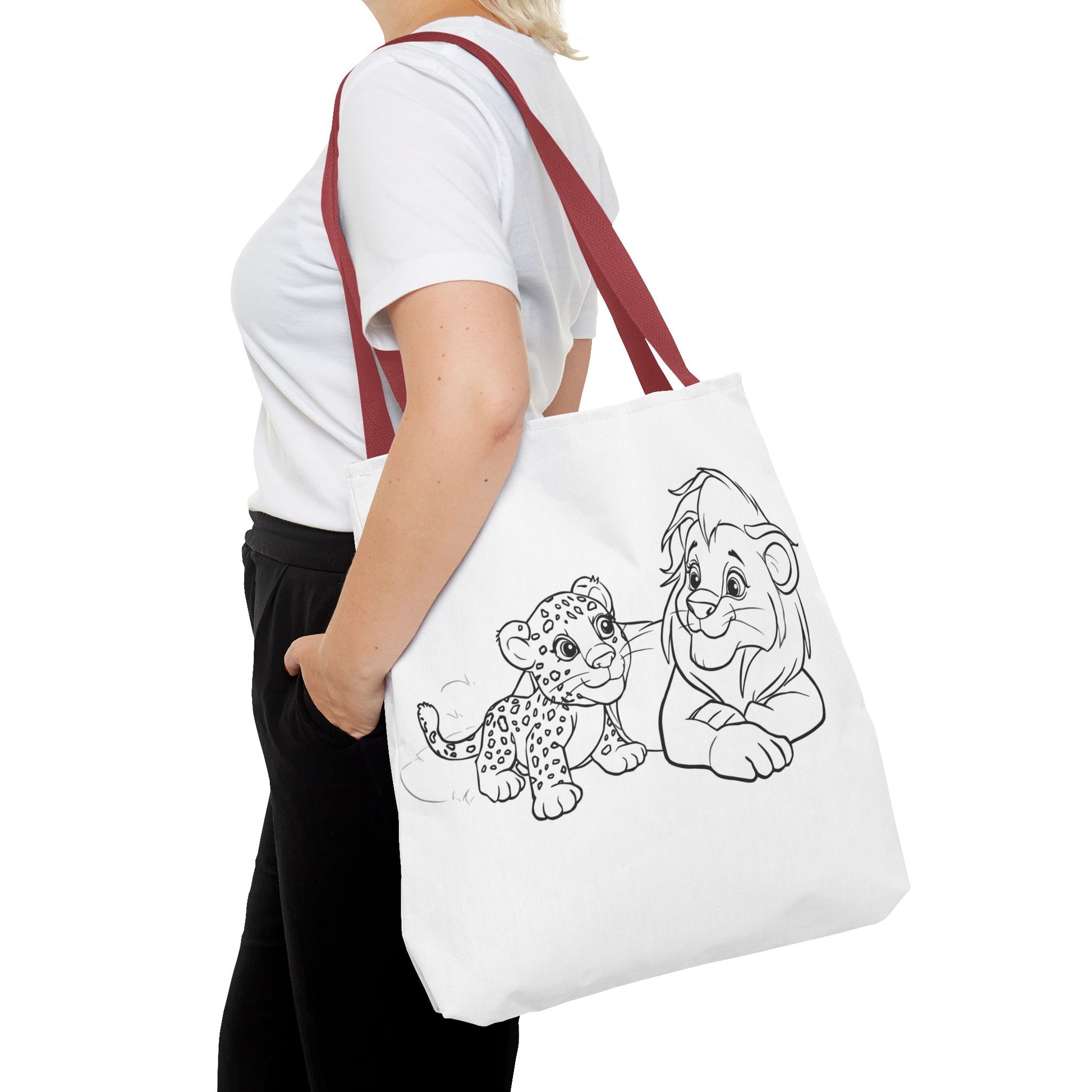 Person holding a tote bag with cartoon lion and cub design on a white background