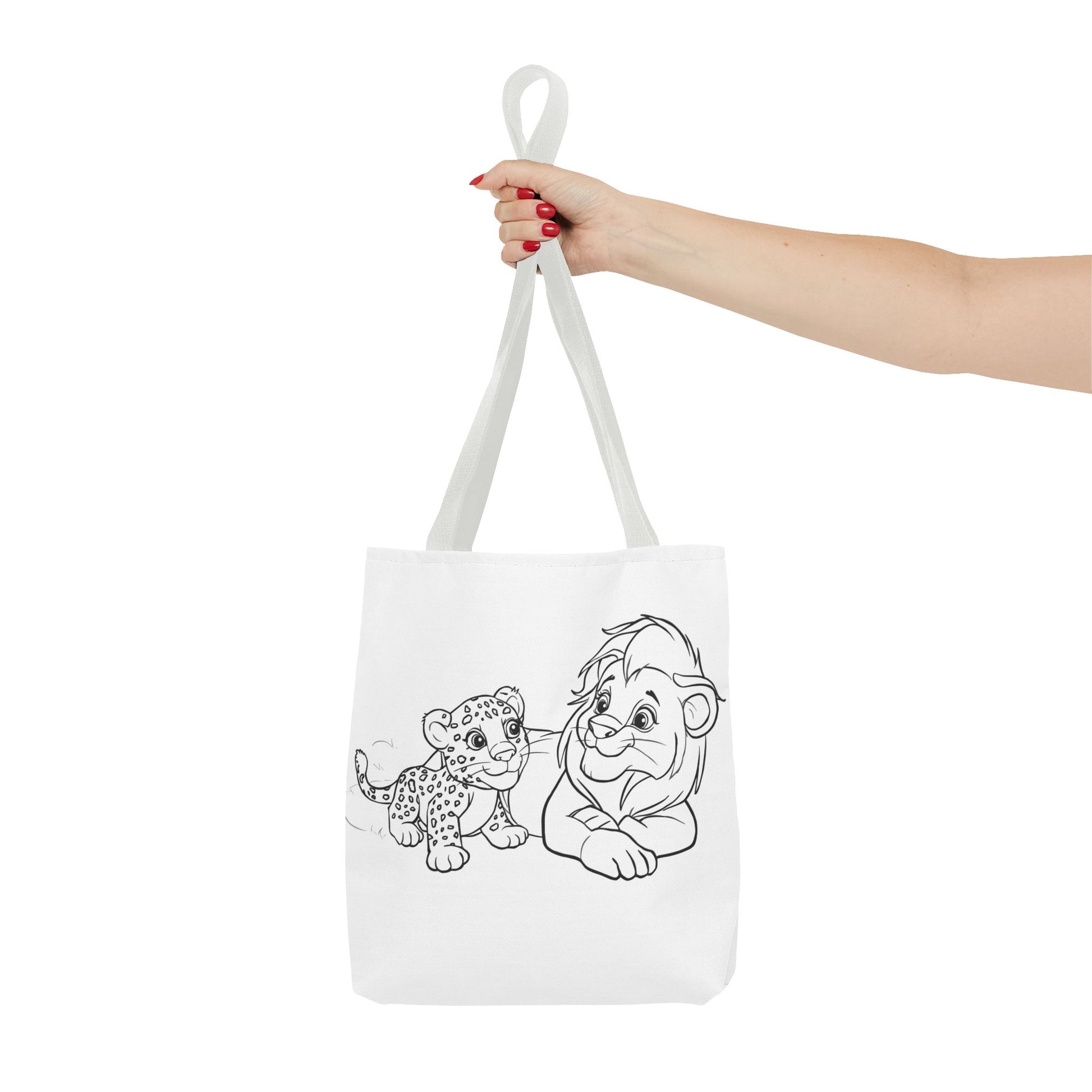 White tote bag with black line art of a lion and cub held by a hand on a white background